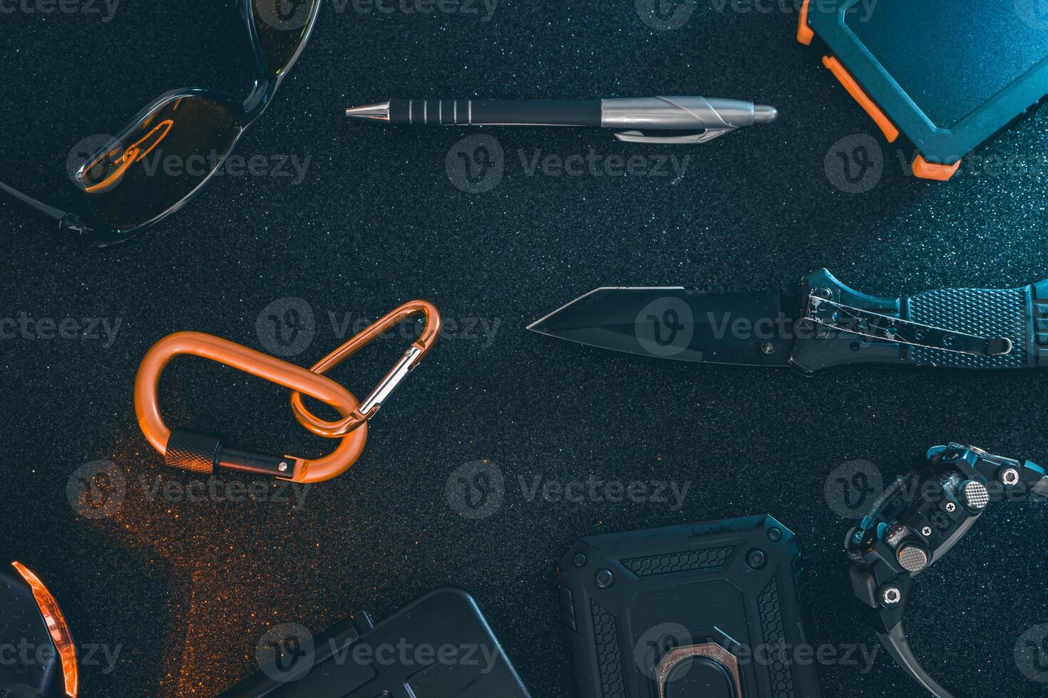 Flat lay of some Outdoor EDC gear on a dark background. photo