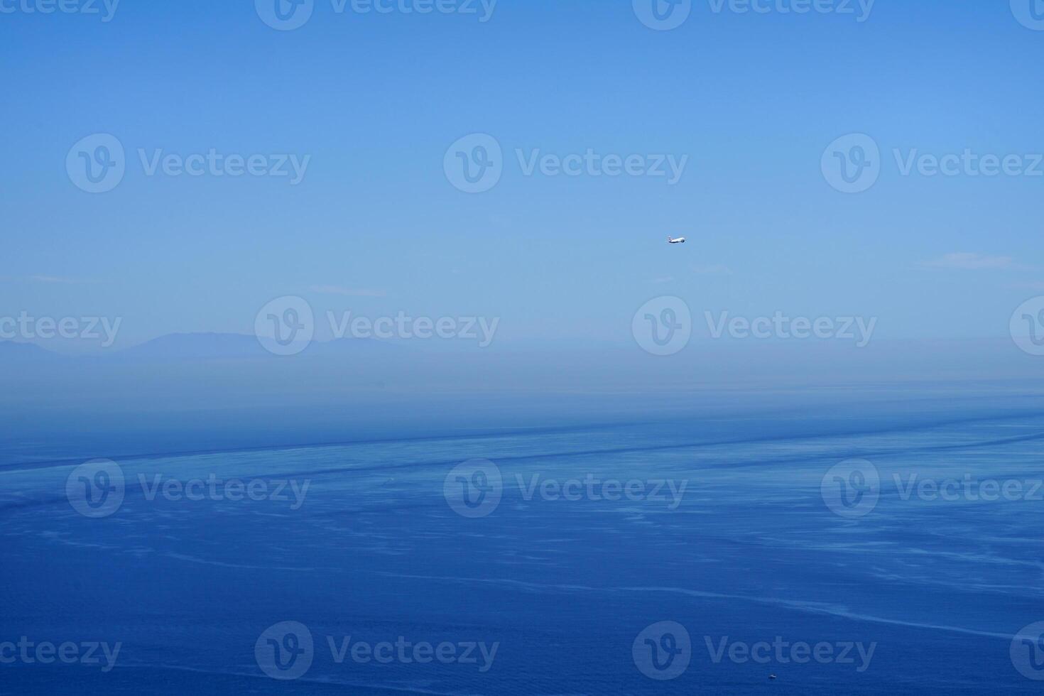 a plane in the immensity of the sky photo