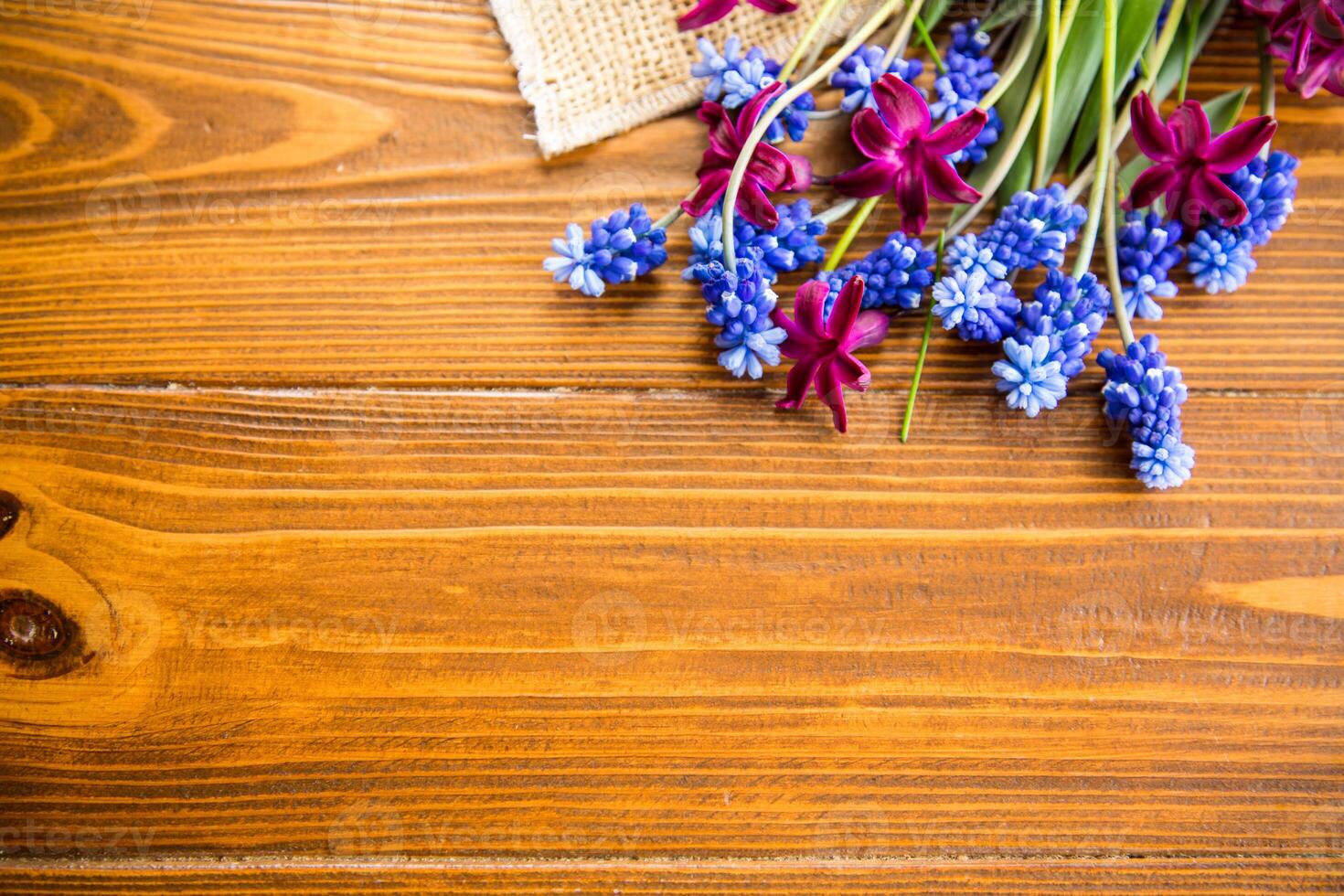beautiful bouquet of spring flowers on a wooden table photo