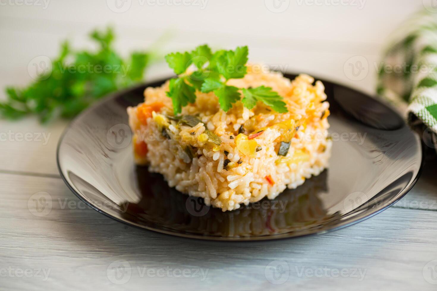Cooked boiled rice with zucchini, carrots and vegetables in a plate photo