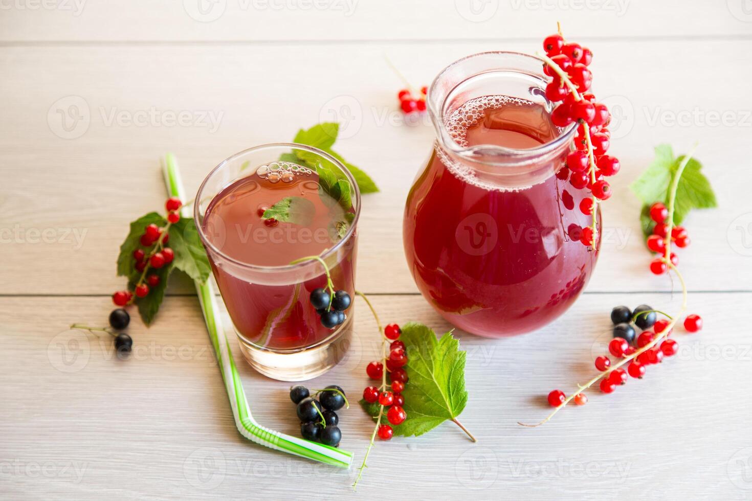 fresh berry juice from red and black currant, on a wooden table photo