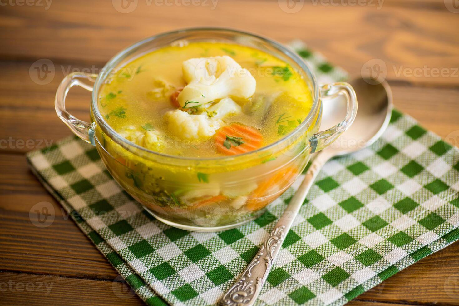 cooked chicken soup with cauliflower and vegetables in a bowl photo