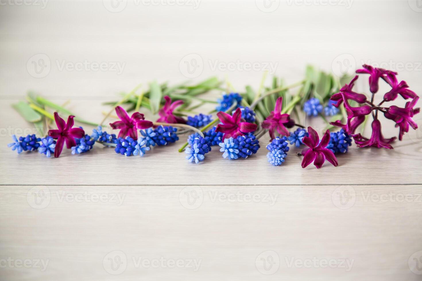 beautiful bouquet of spring flowers on a wooden table photo