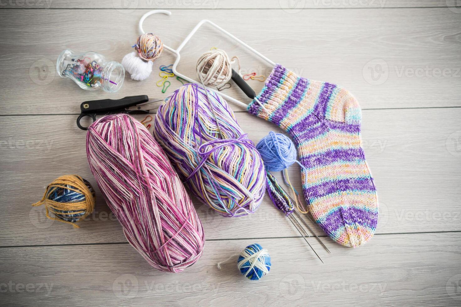 Colored threads, knitting needles and other items for hand knitting photo