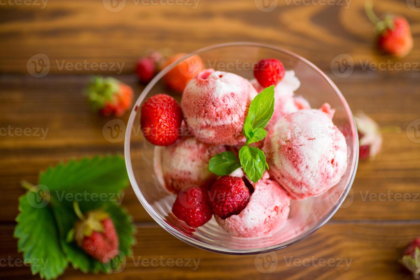 Balls of homemade strawberry ice cream in a bowl photo
