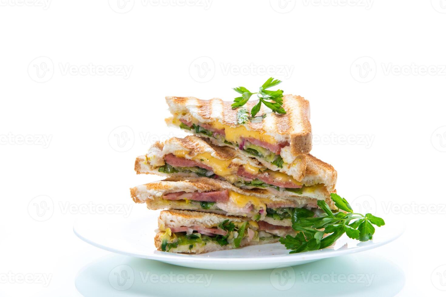 fried toasts stuffed with sausage, cheese and greens inside, on white background. photo