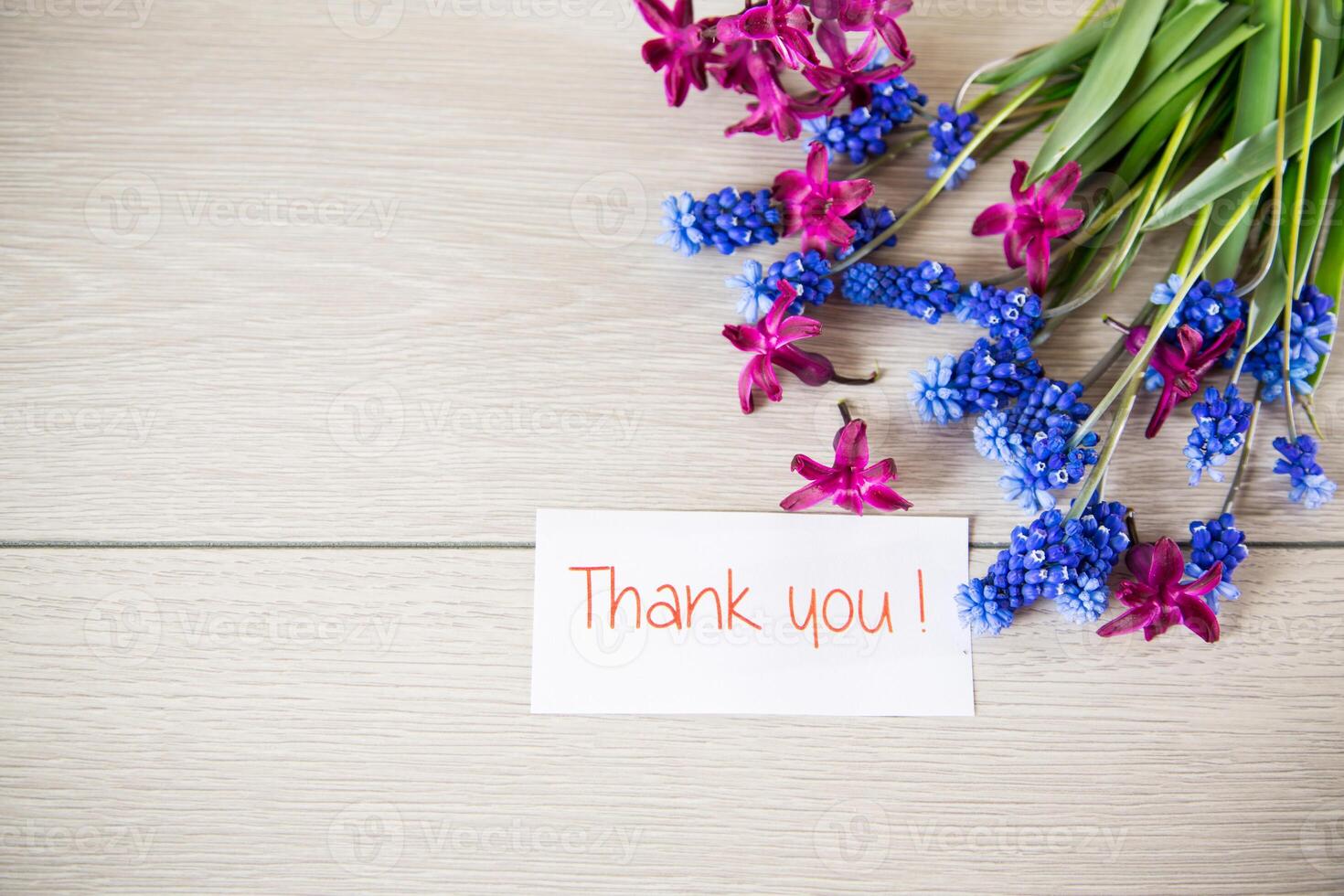 beautiful bouquet of spring flowers on a wooden table photo