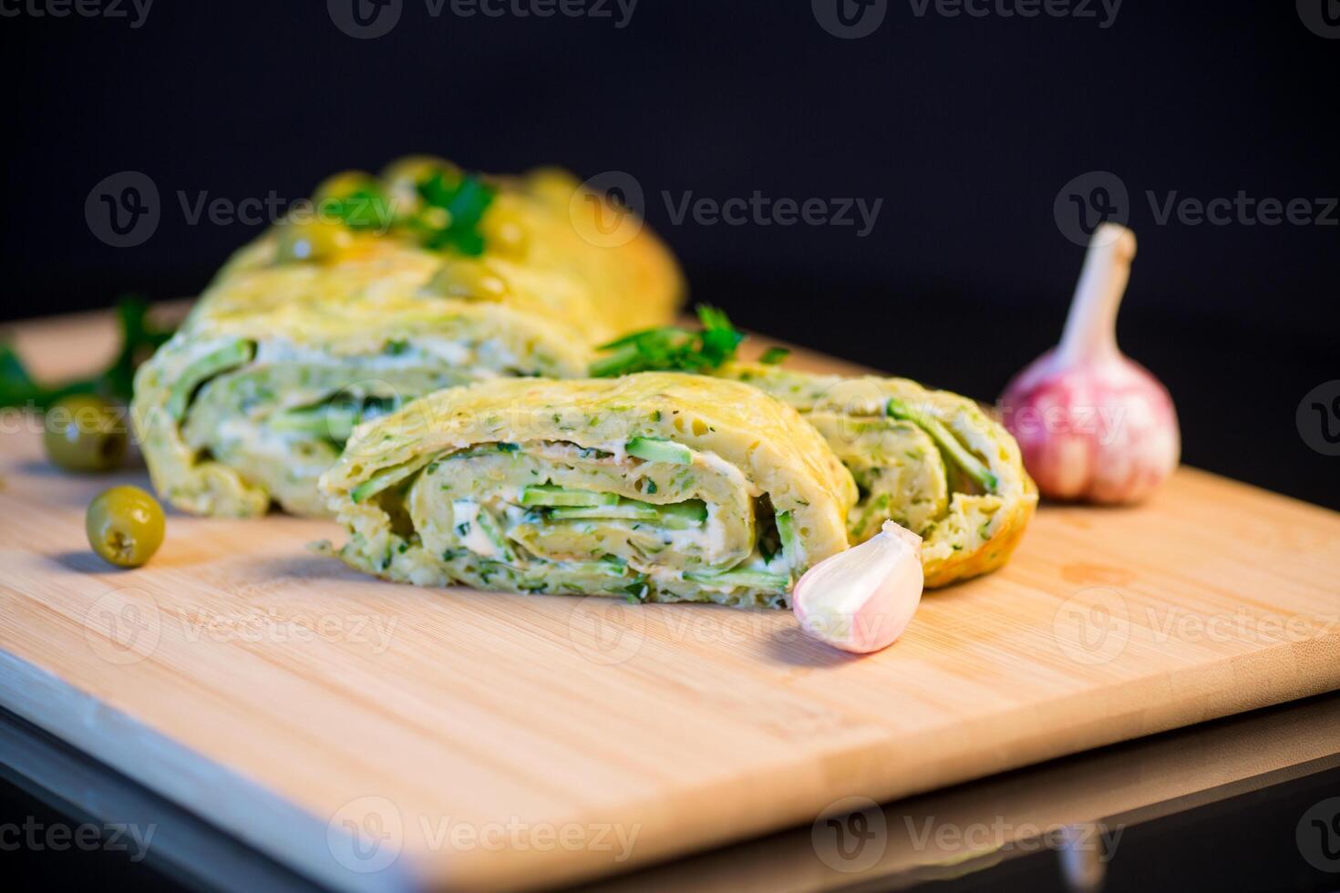 vegetable zucchini roll with garlic cheese filling inside. photo