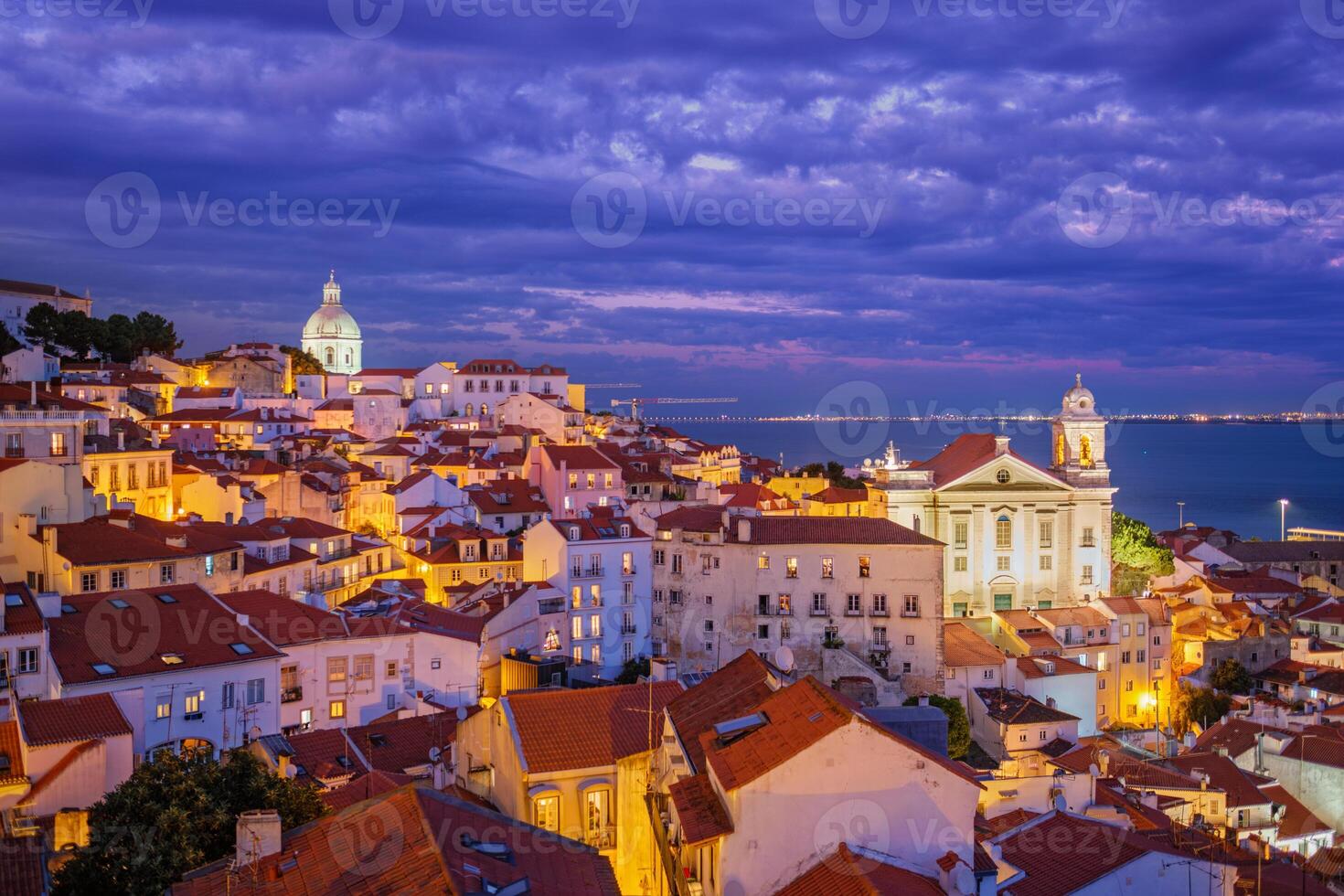 View of Lisbon from Miradouro de Santa Luzia viewpoint at evening. Lisbon, Portugal photo