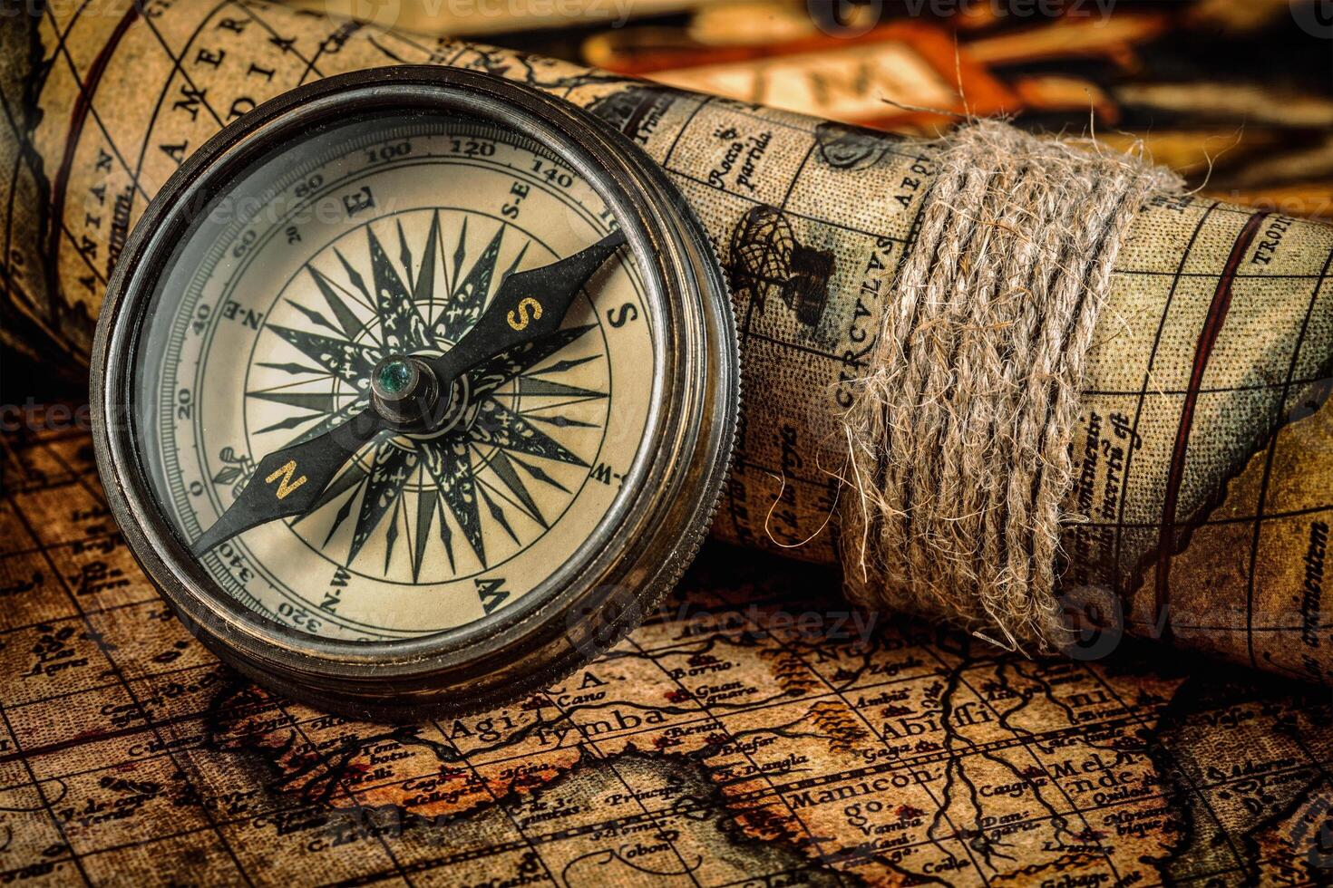 Old vintage compass on ancient map photo