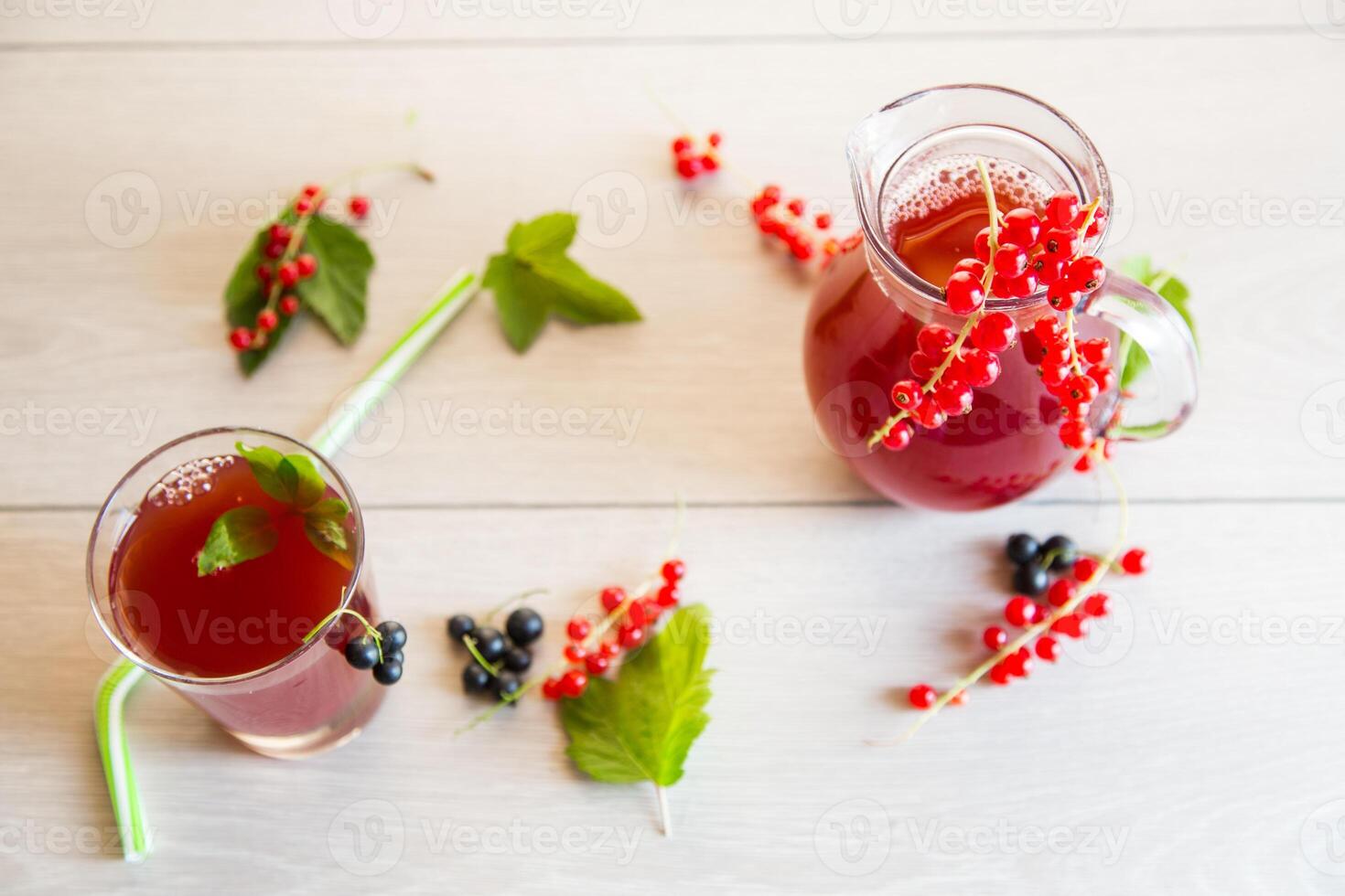 fresh berry juice from red and black currant, on a wooden table photo
