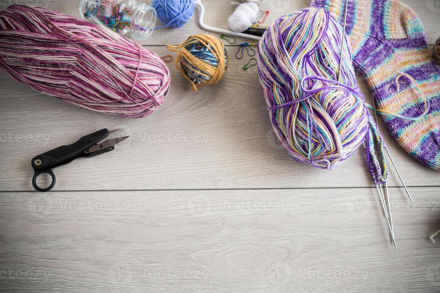 Colored threads, knitting needles and other items for hand knitting photo