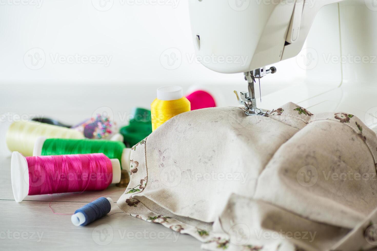 Sewing machine with fabric and threads for sewing, close-up. The working process photo