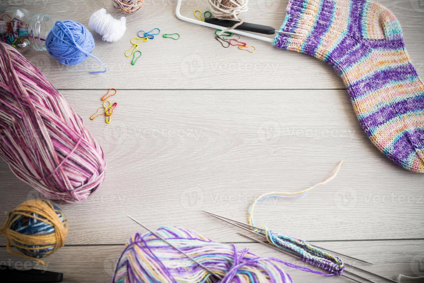 Colored threads, knitting needles and other items for hand knitting photo