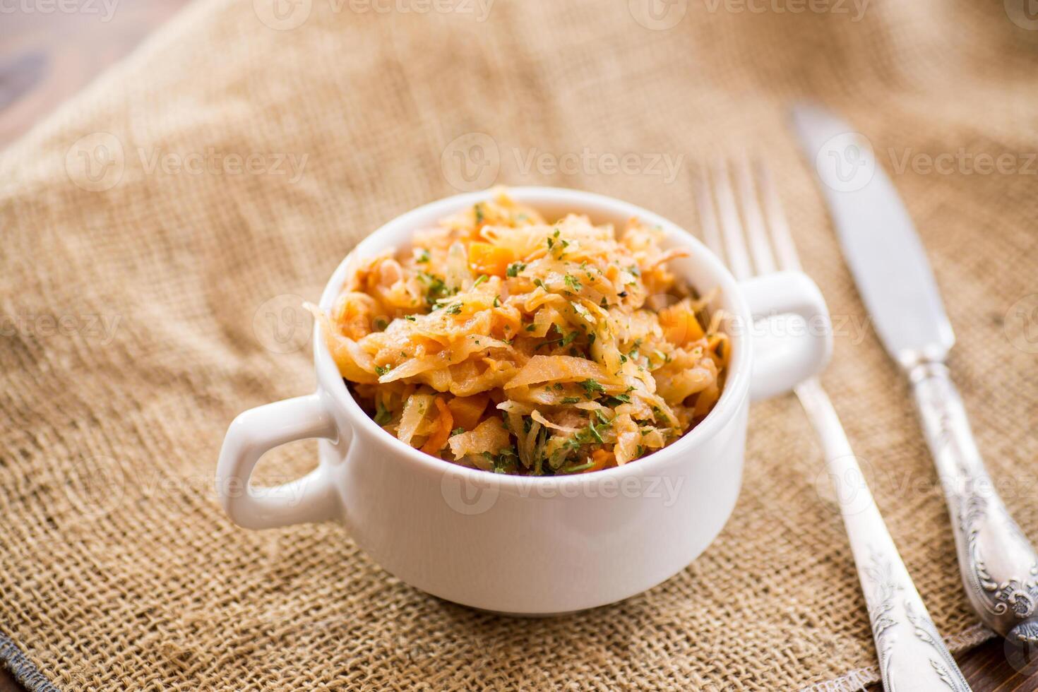 stewed cabbage with carrots and spices in a bowl photo
