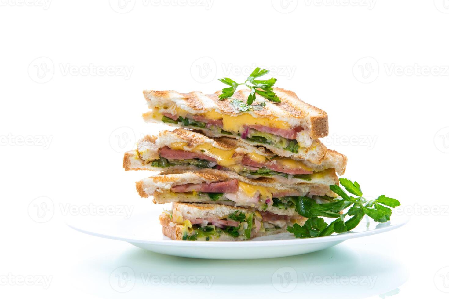 fried toasts stuffed with sausage, cheese and greens inside, on white background. photo