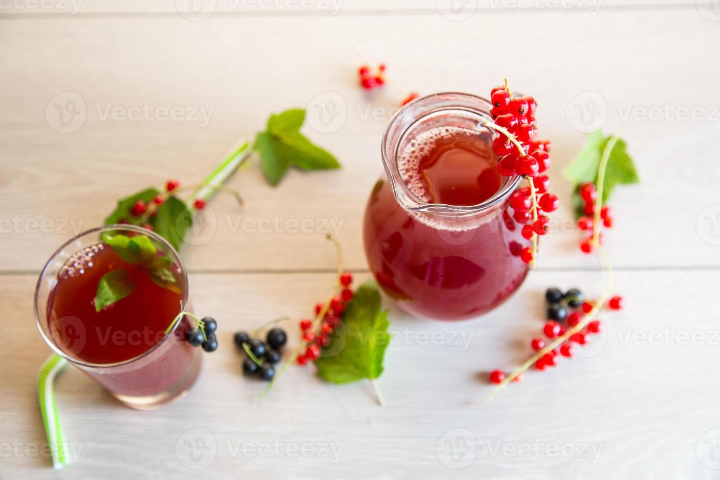 fresh berry juice from red and black currant, on a wooden table photo