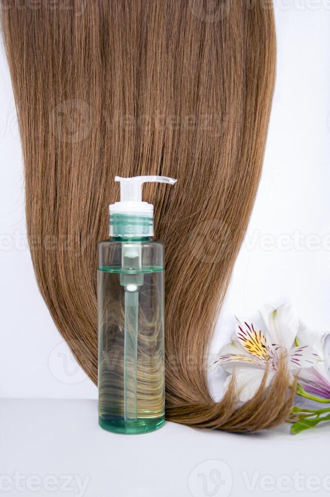 Cosmetic hair oil on a white background. Hair care. Healthy and beautiful hair. Copy space for text photo