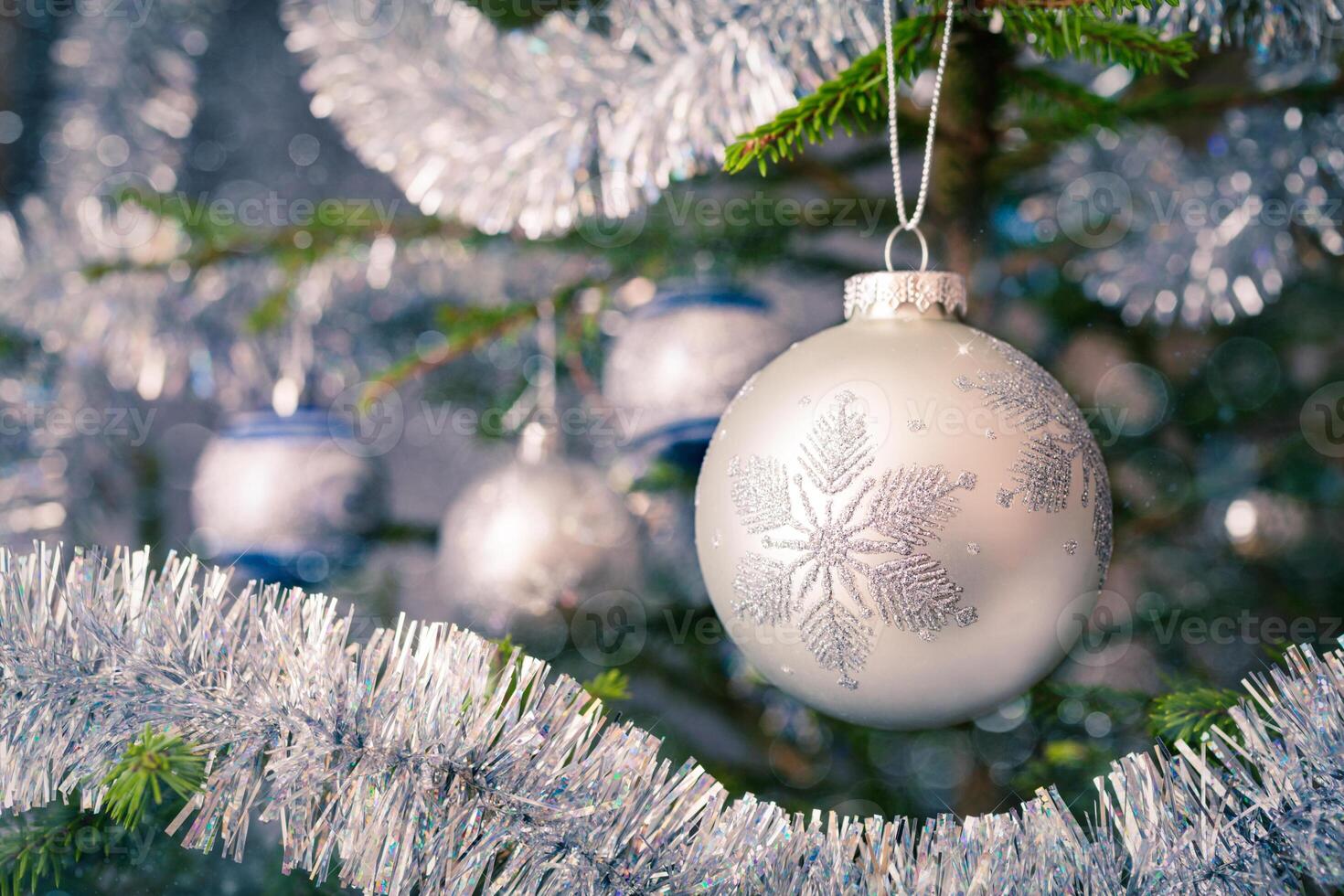 Christmas-tree decoration bauble on decorated Christmas tree bac photo