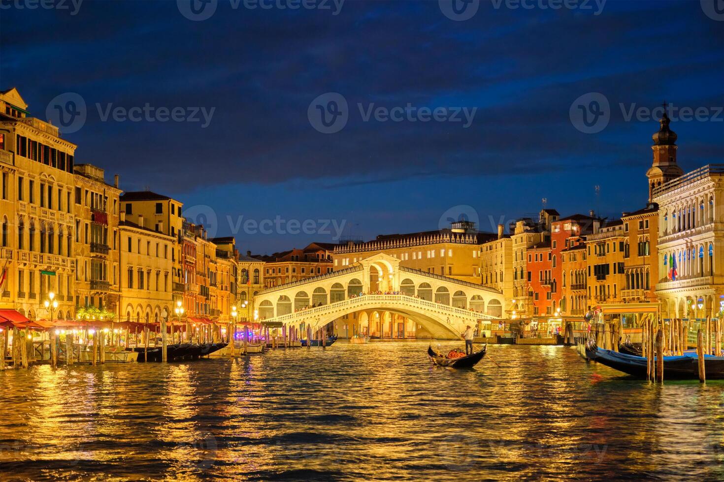 Rialto bridge Ponte di Rialto over Grand Canal at night in Venice, Italy photo