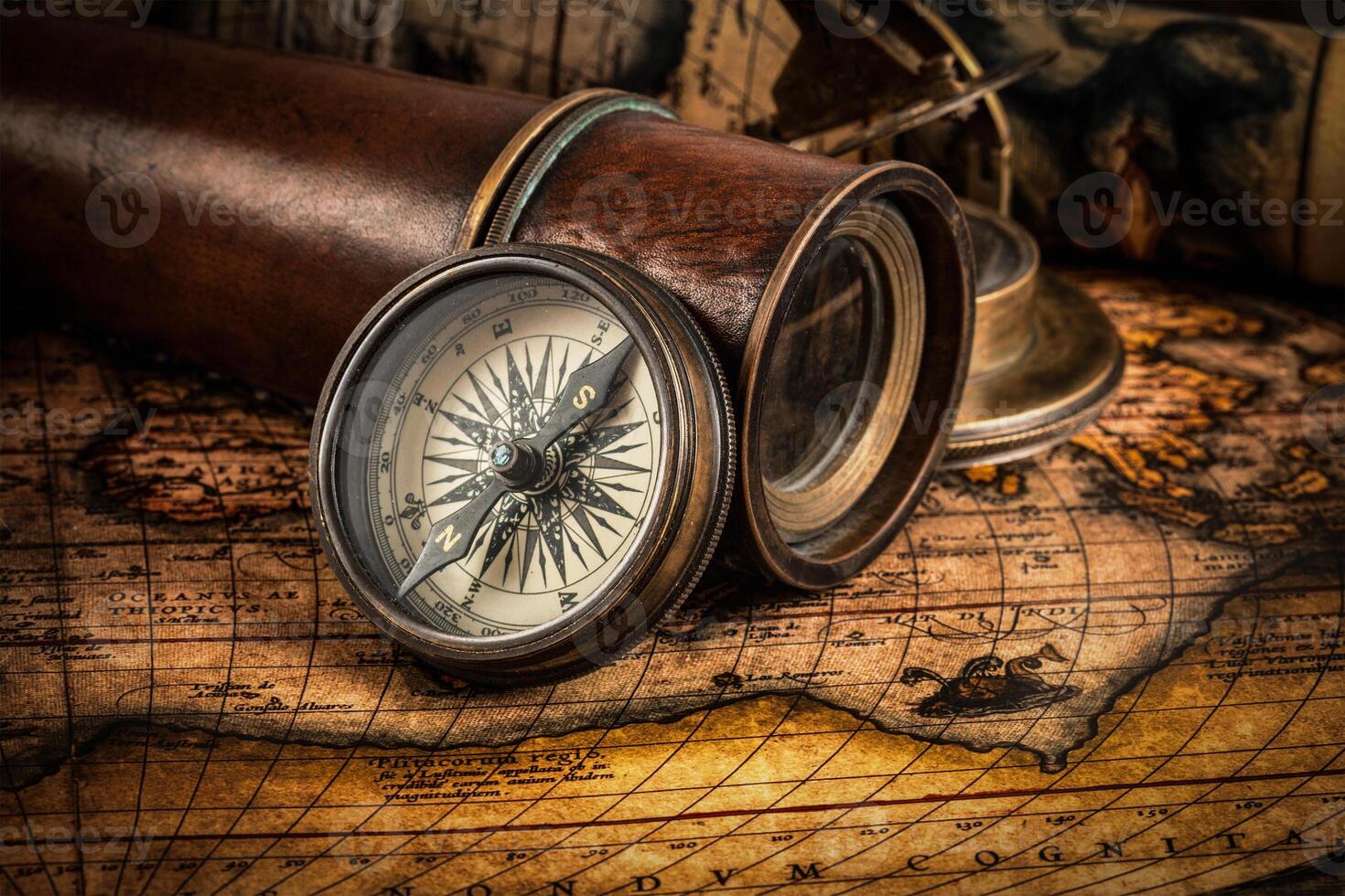 Old vintage compass on ancient map photo