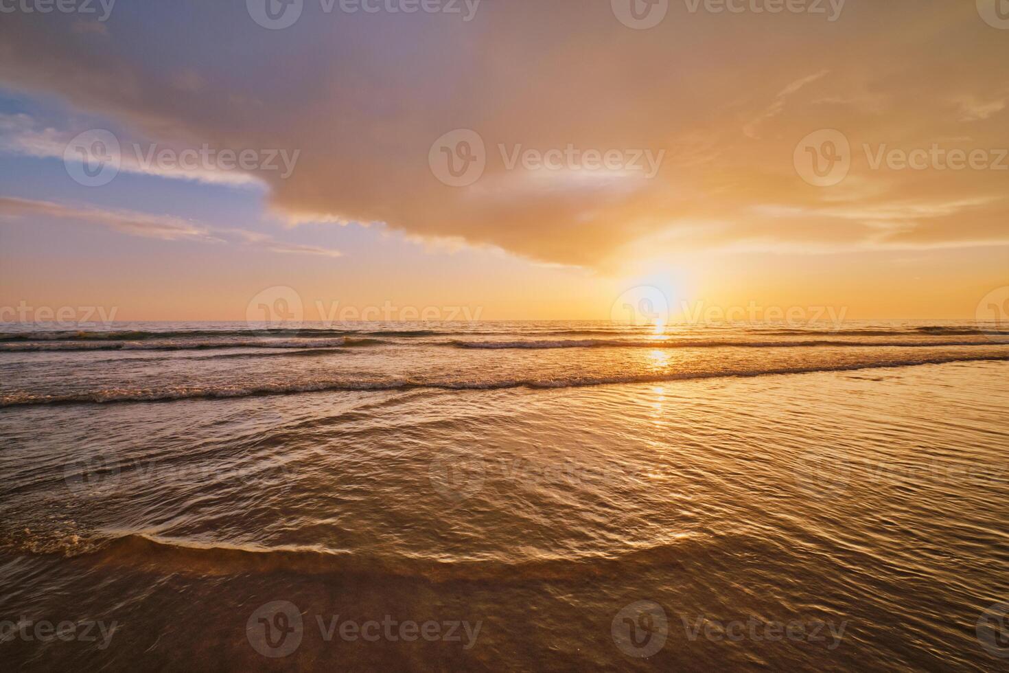 Atlantic ocean sunset with surging waves at Fonte da Telha beach, Portugal photo