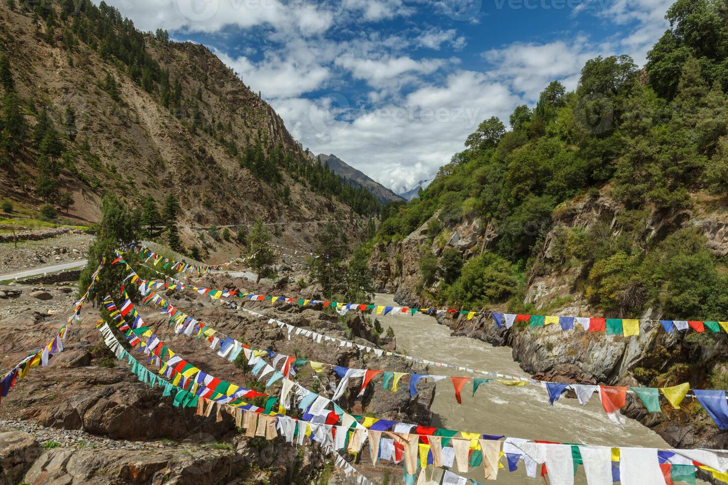 Lungta buddhist prayer flags in Lahaul valley over Chandra river photo