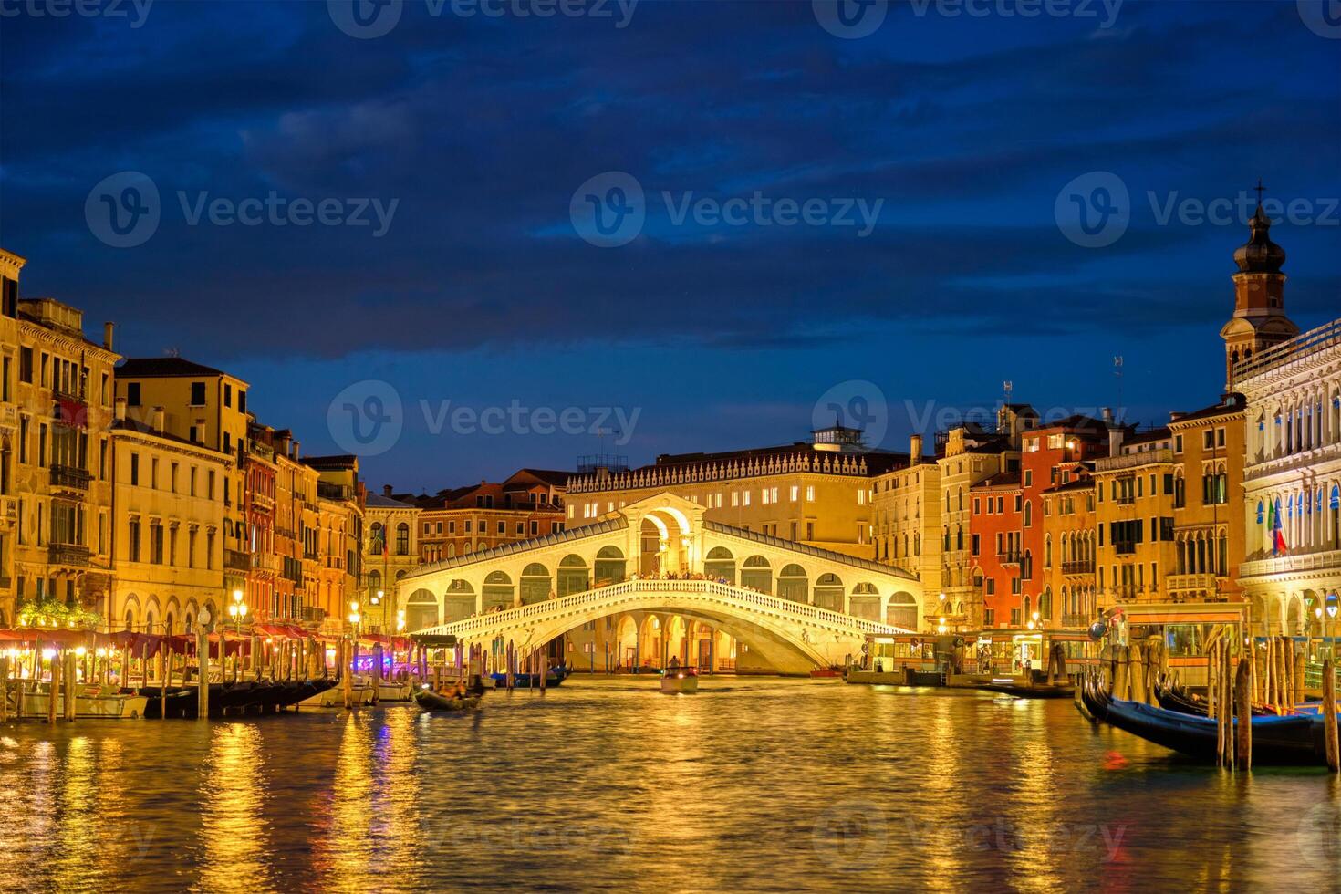 Rialto bridge Ponte di Rialto over Grand Canal at night in Venice, Italy photo