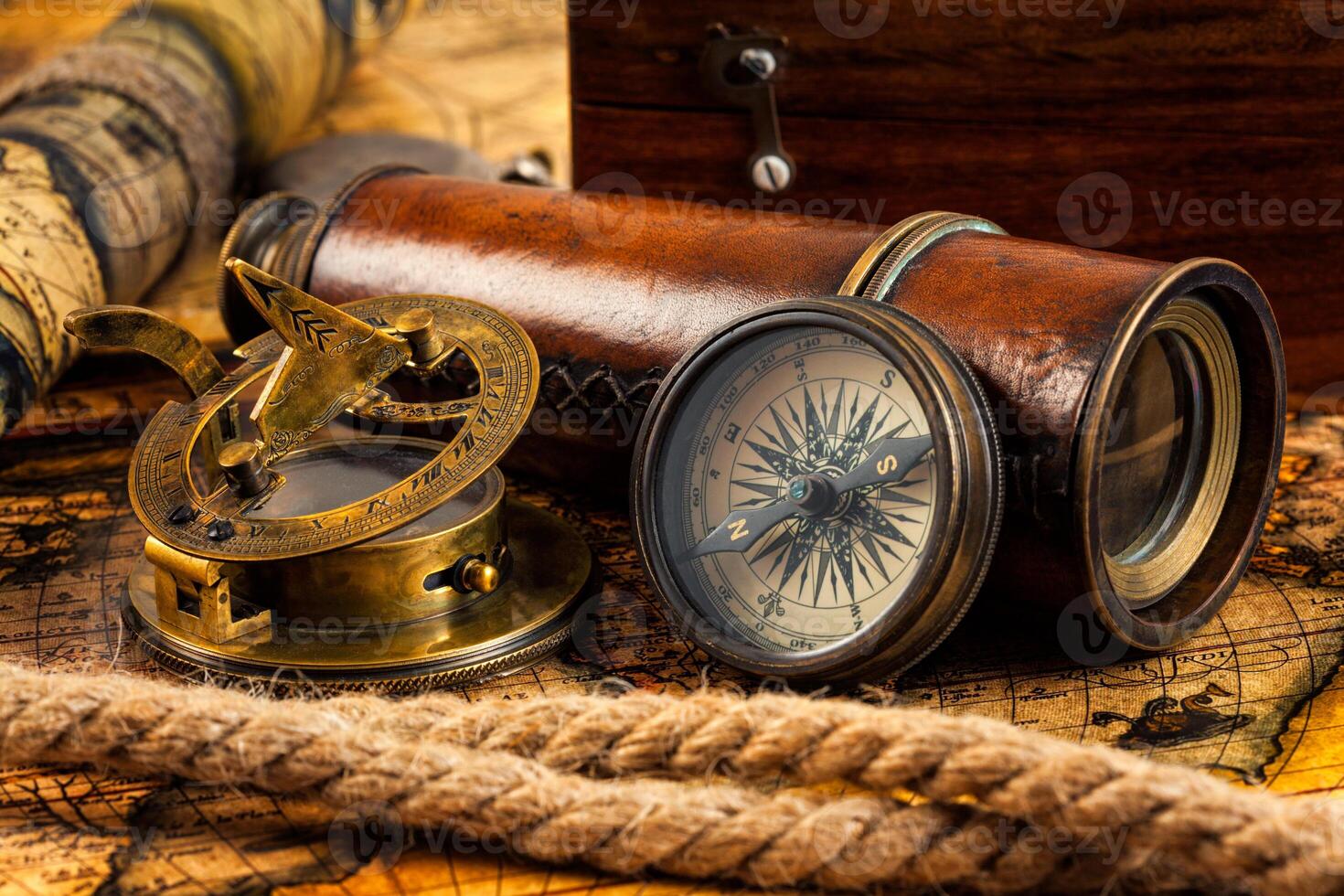 Old vintage compass and navigation instruments on ancient map photo