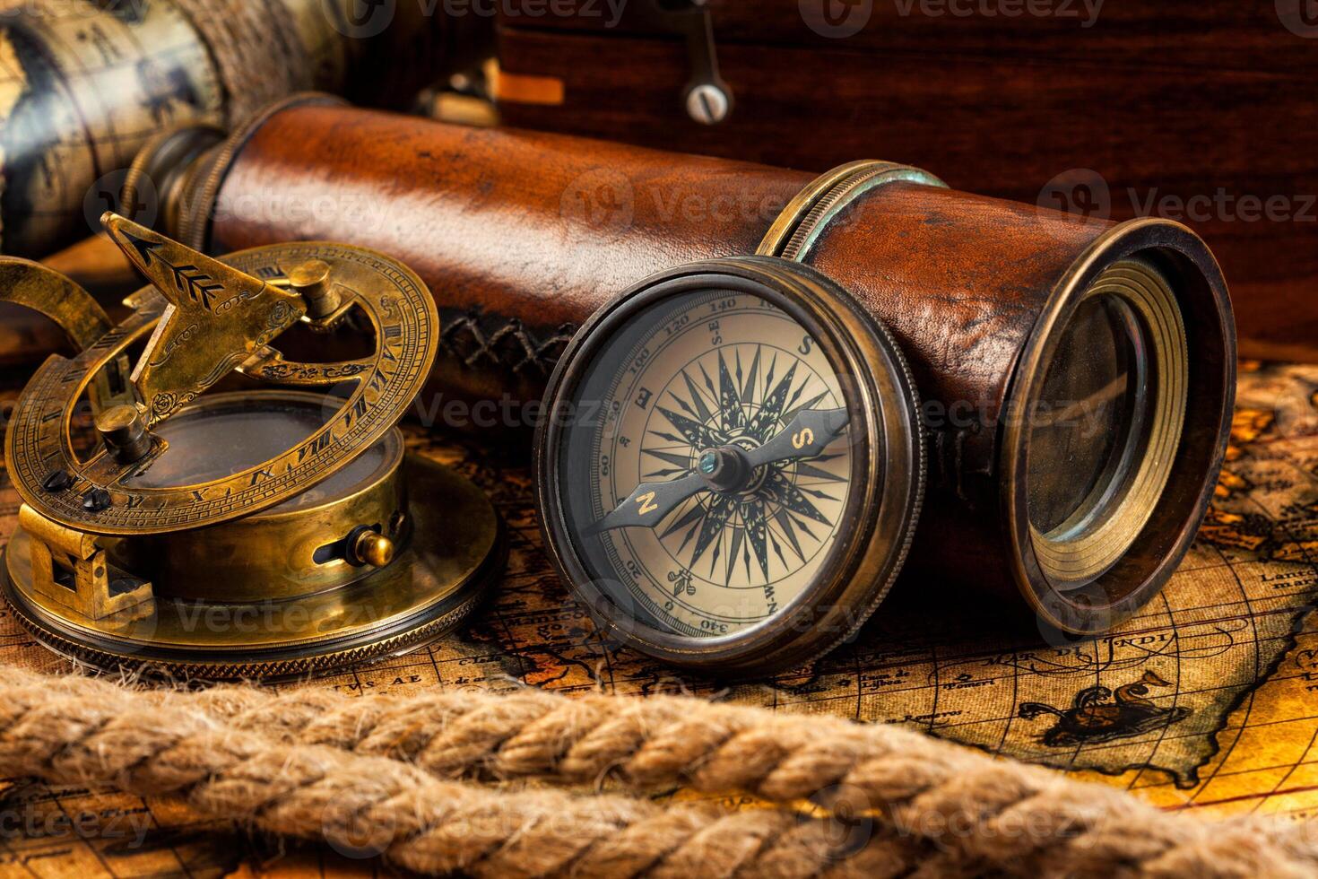Old vintage compass and navigation instruments on ancient map photo