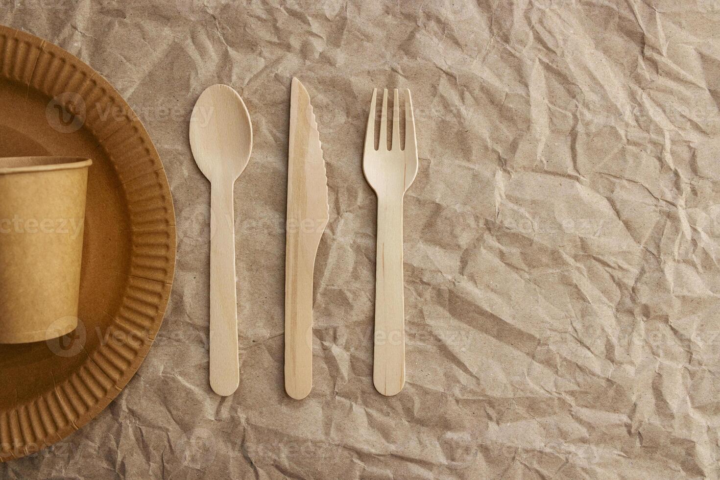 A set of disposable tableware on a paper background photo