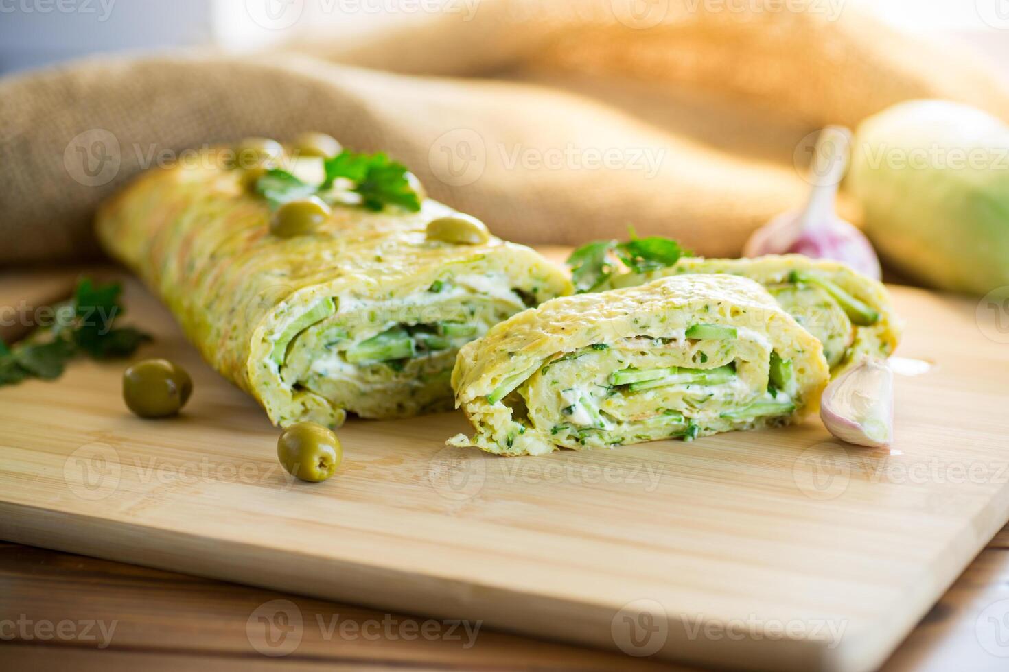 vegetable zucchini roll with garlic cheese filling inside. photo