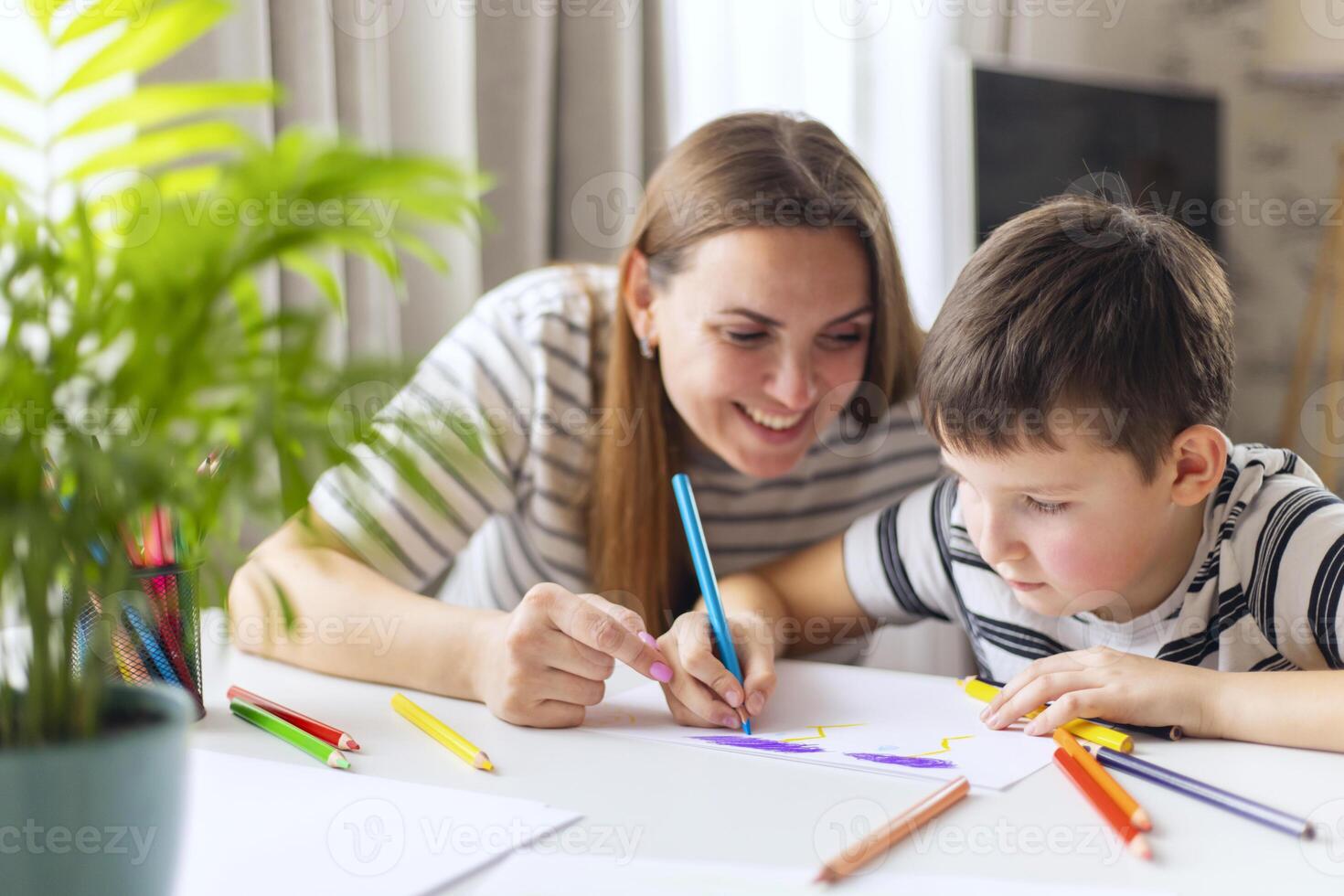 Mother and her son drawing together photo