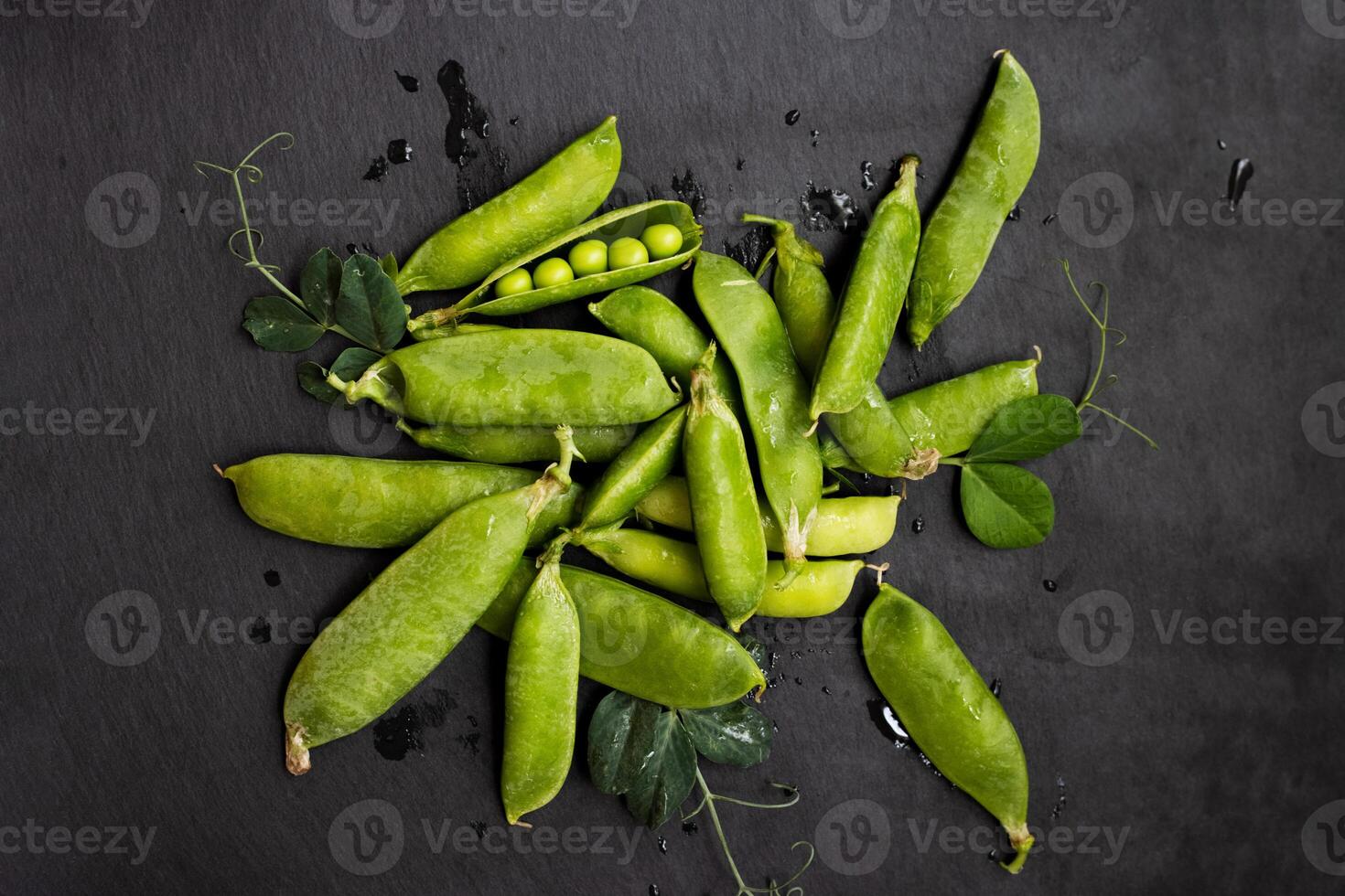 Fresh Green Peas on Dark Slate Background photo