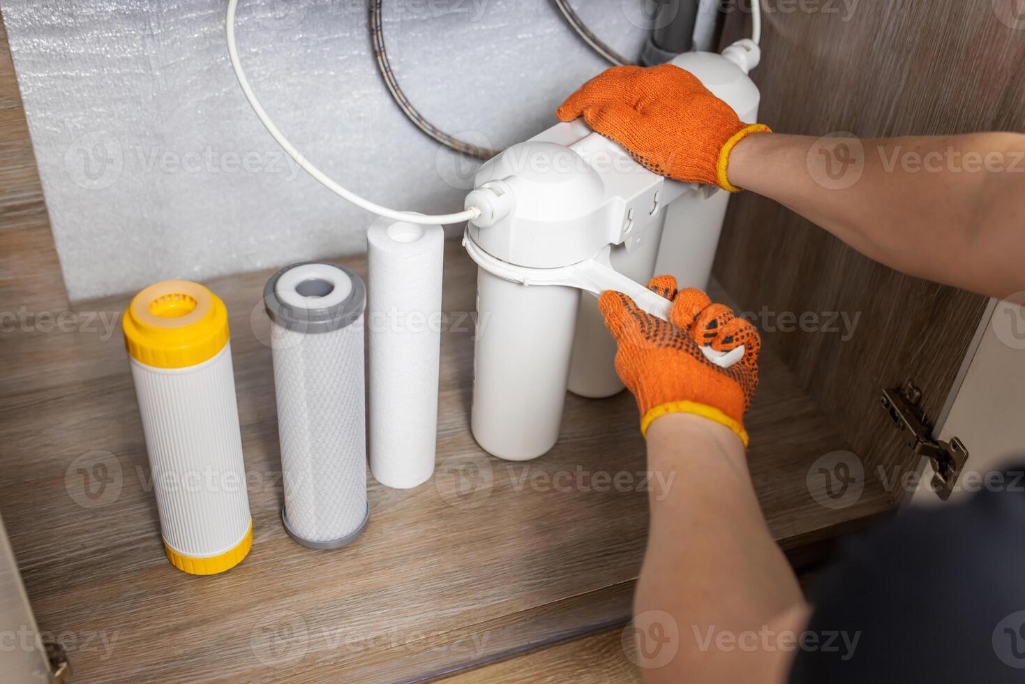Plumber installs or change water filter. Replacement aqua filter. photo
