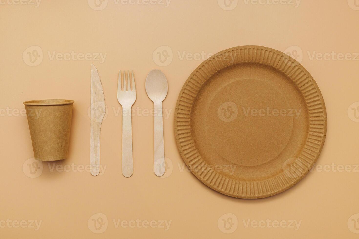 A set of disposable tableware on a brown background photo