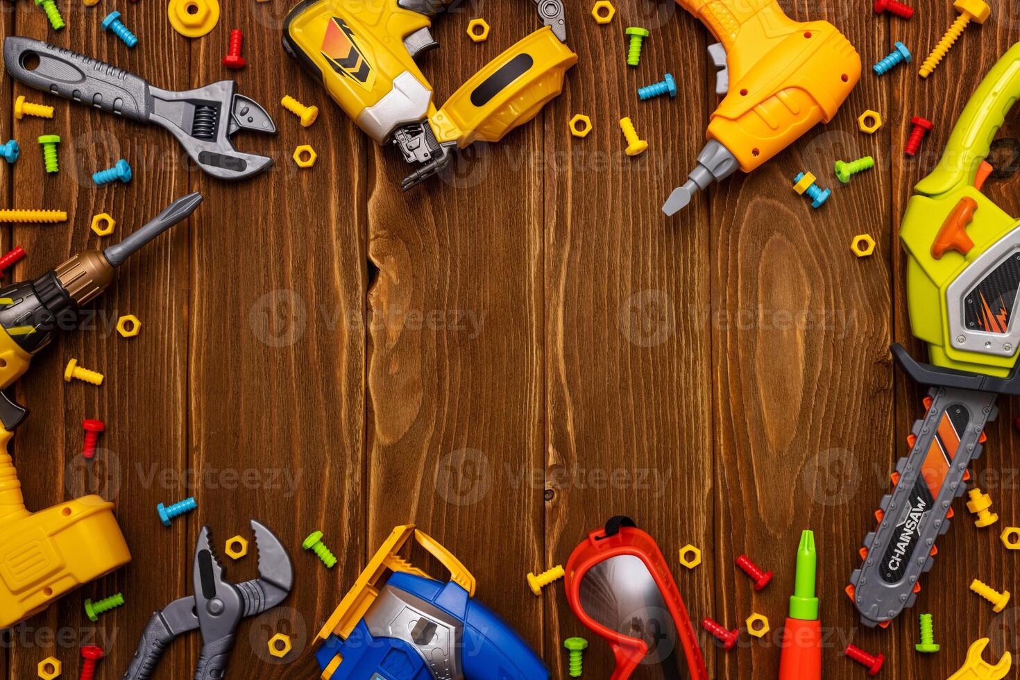 Toy tools, bolts and nuts on wooden background with a place for your text photo