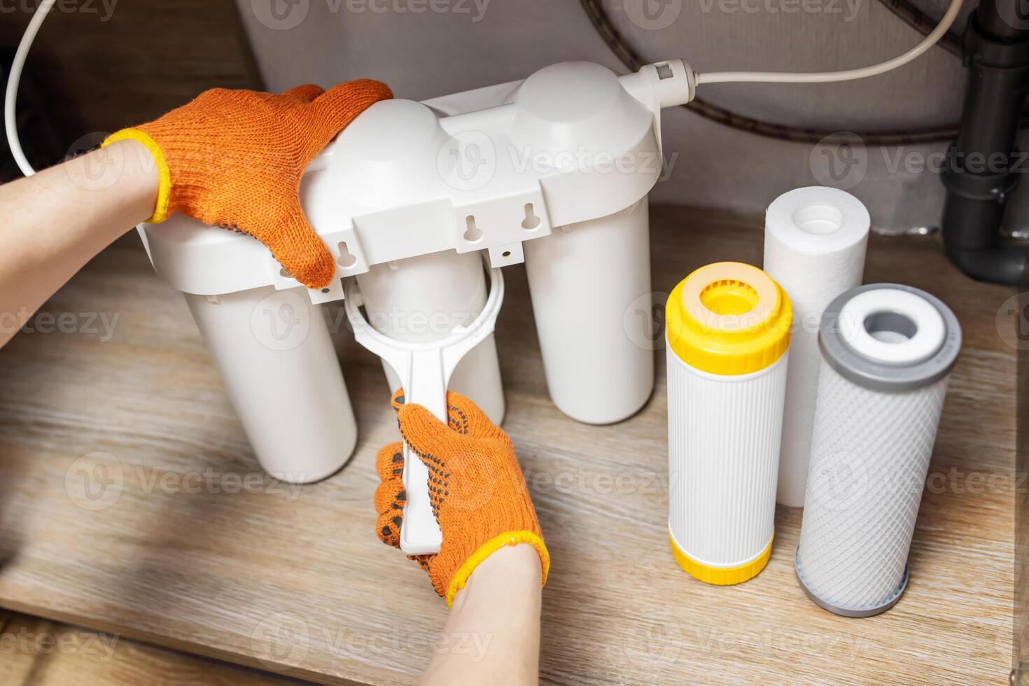 Plumber installs or change water filter. Replacement aqua filter. photo
