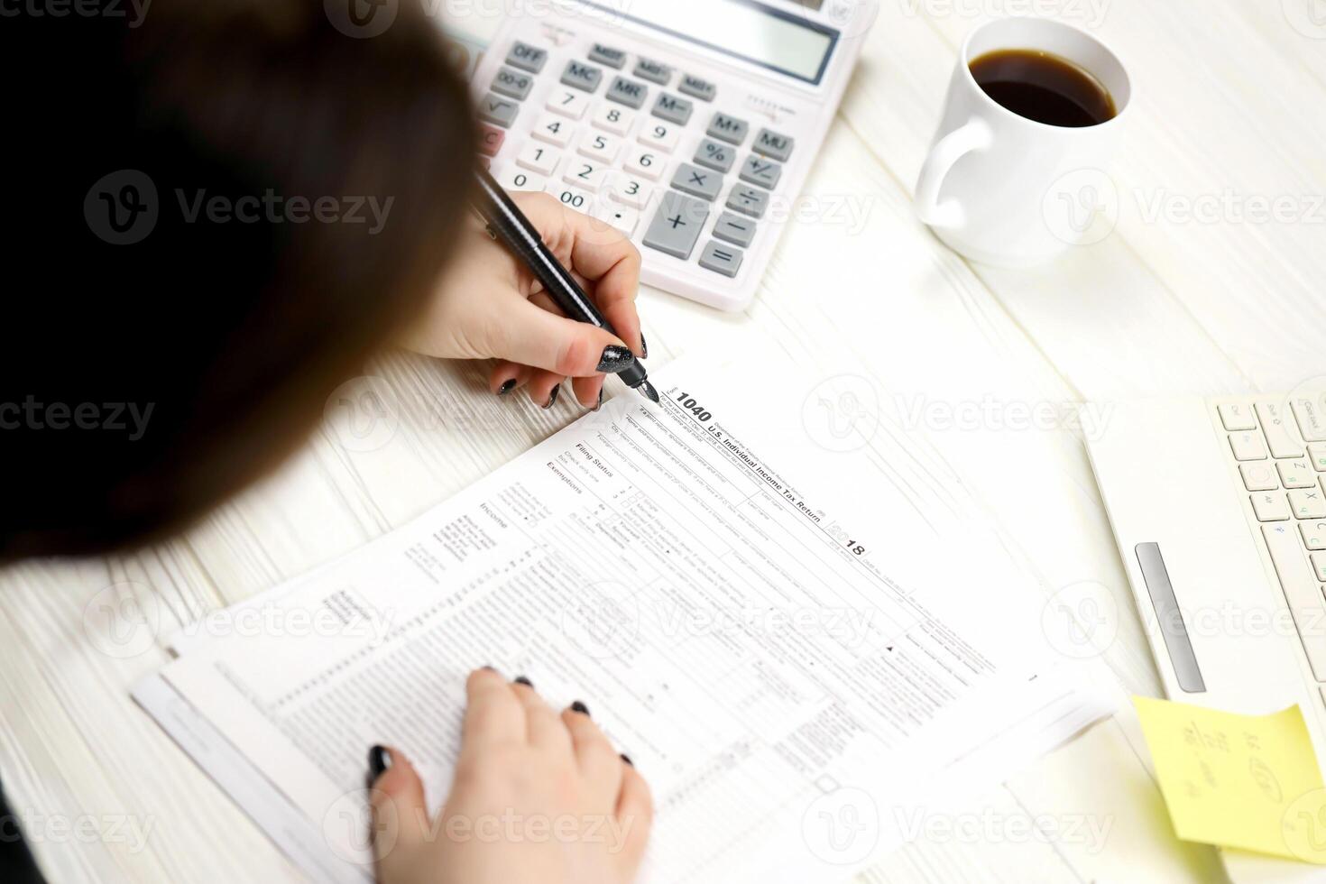 Accountant fill American tax form 1040 Individual income tax return in end of tax period. Taxation and paperwork routine photo