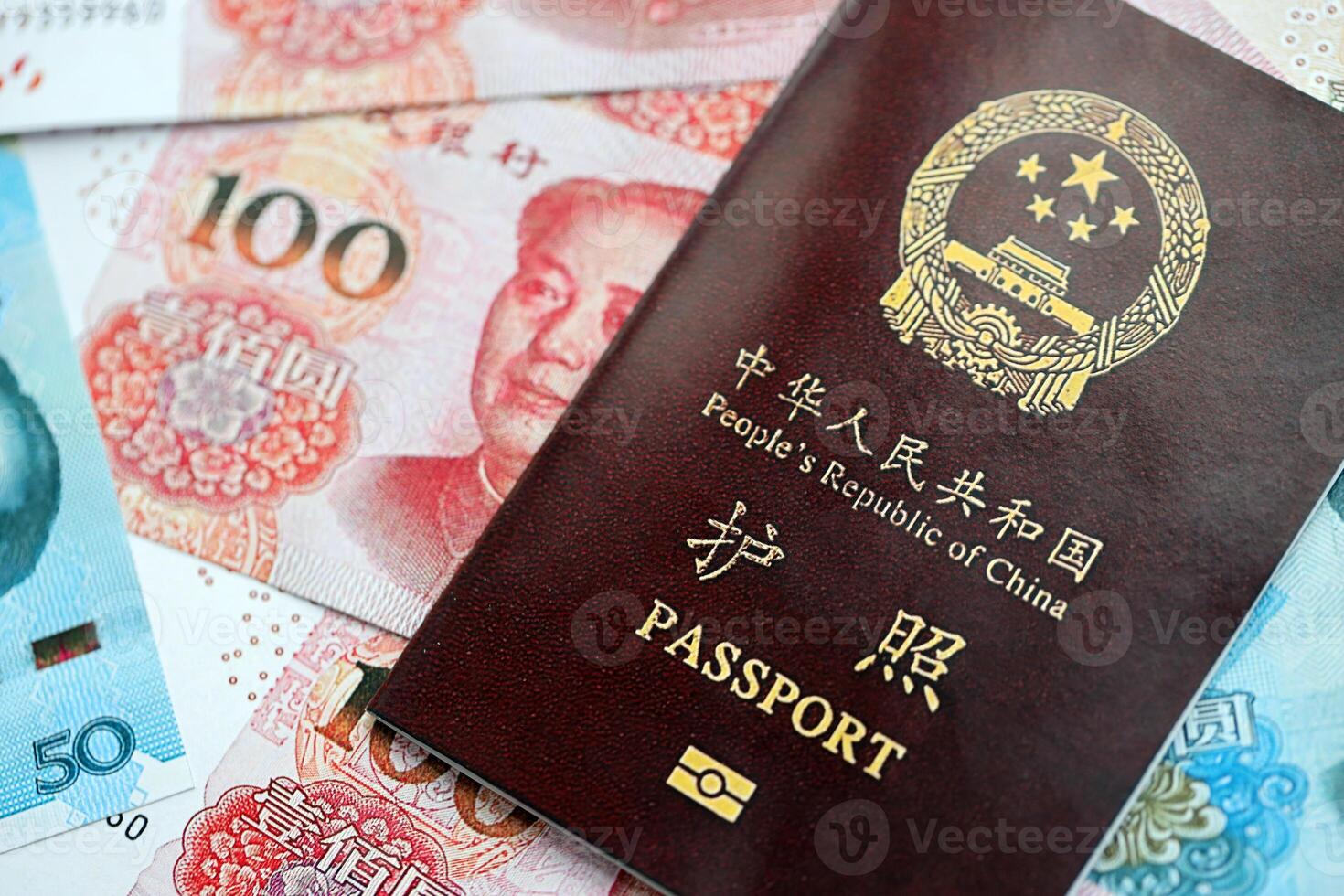 Red passport of People Republic of China and chinese yuan money bills. PRC chinese passport photo