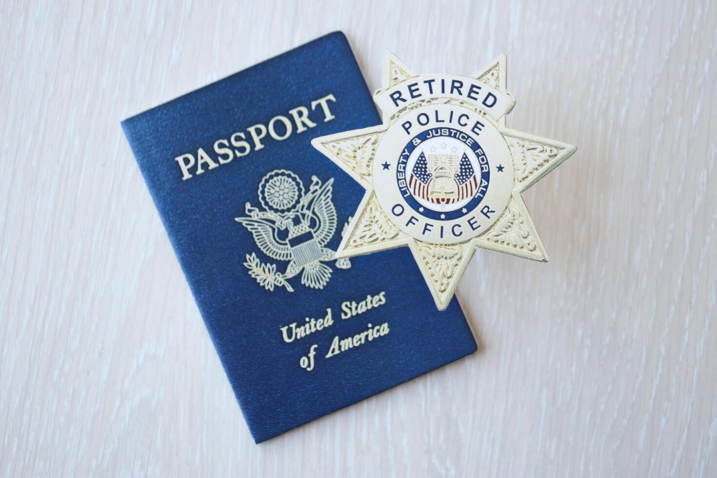 KYIV, UKRAINE - MARCH 9, 2024 US Retired Police Officer badge and United States passport on wooden table photo