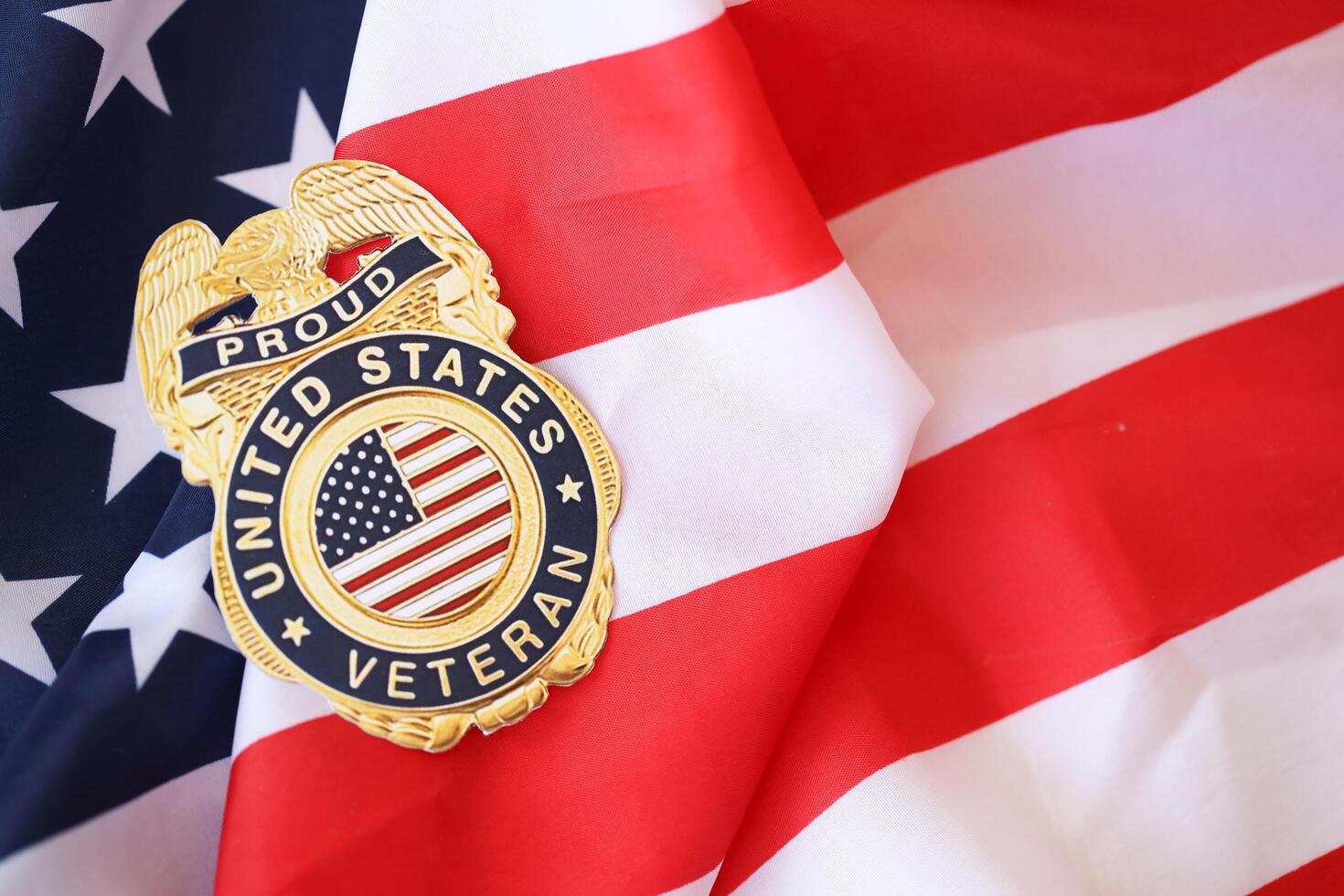 KYIV, UKRAINE - MARCH 9, 2024 US Proud Veteran badge on United States of America flag photo