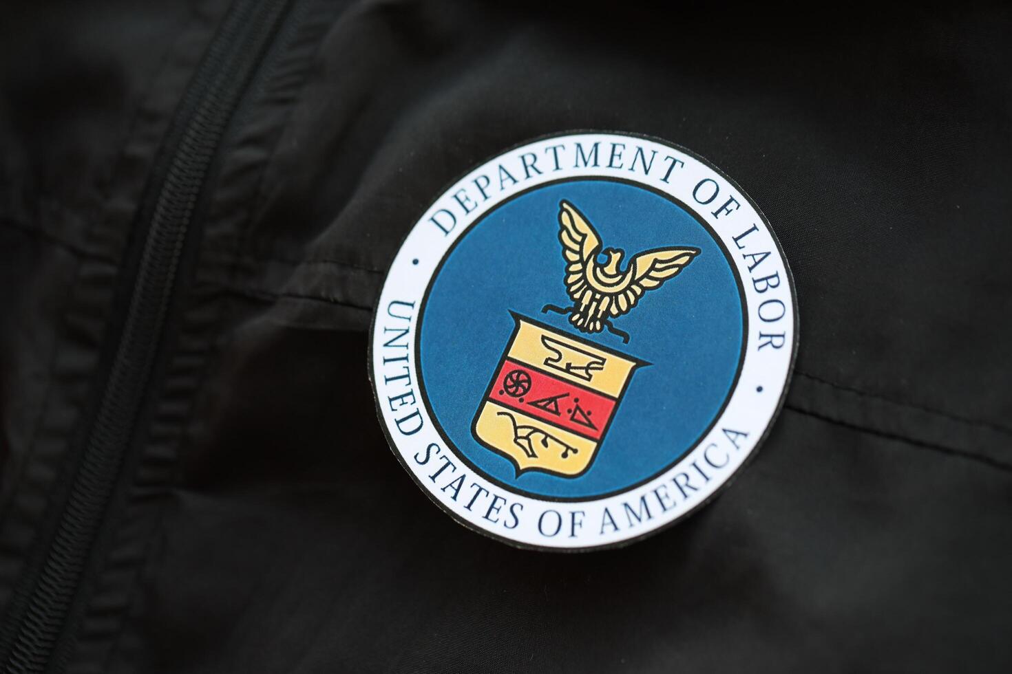 KYIV, UKRAINE - MARCH 9, 2024 US Department of Labor seal on black jacket uniform photo