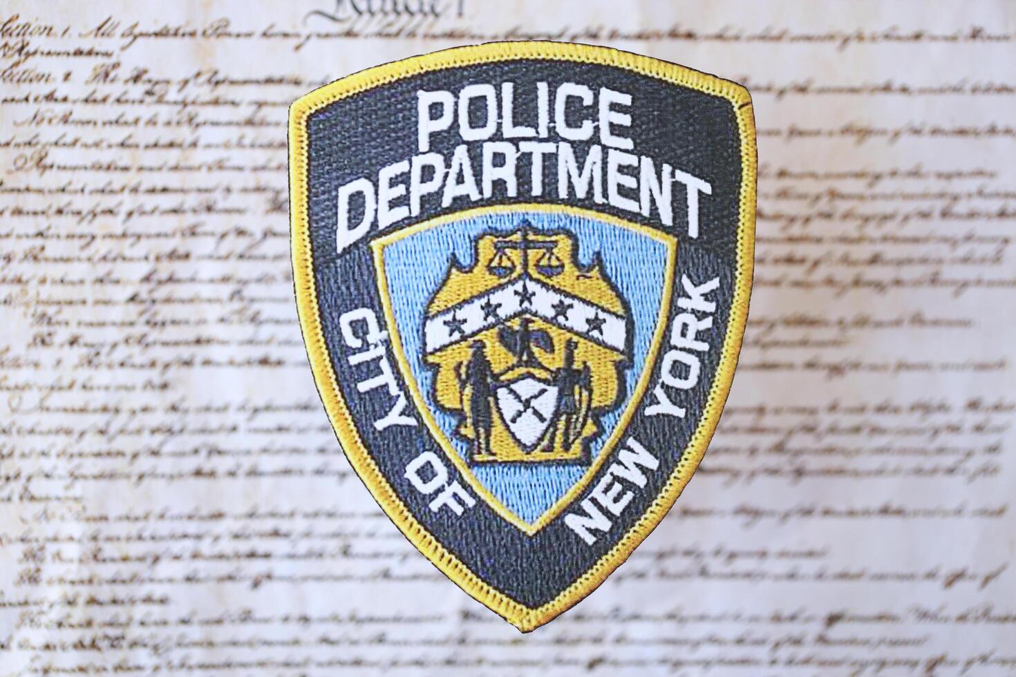 KYIV, UKRAINE - MARCH 9, 2024 US NYPD Police patch on United States Constitution photo