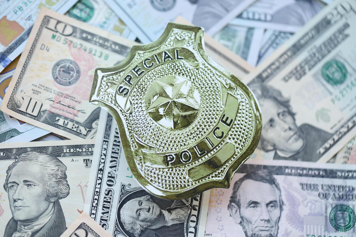 KYIV, UKRAINE - MARCH 9, 2024 US Special Police badge on many US dollar bills photo