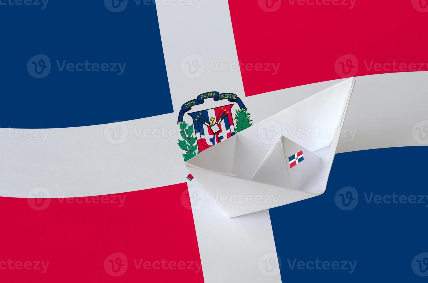 Dominican Republic flag depicted on paper origami ship closeup. Handmade arts concept photo