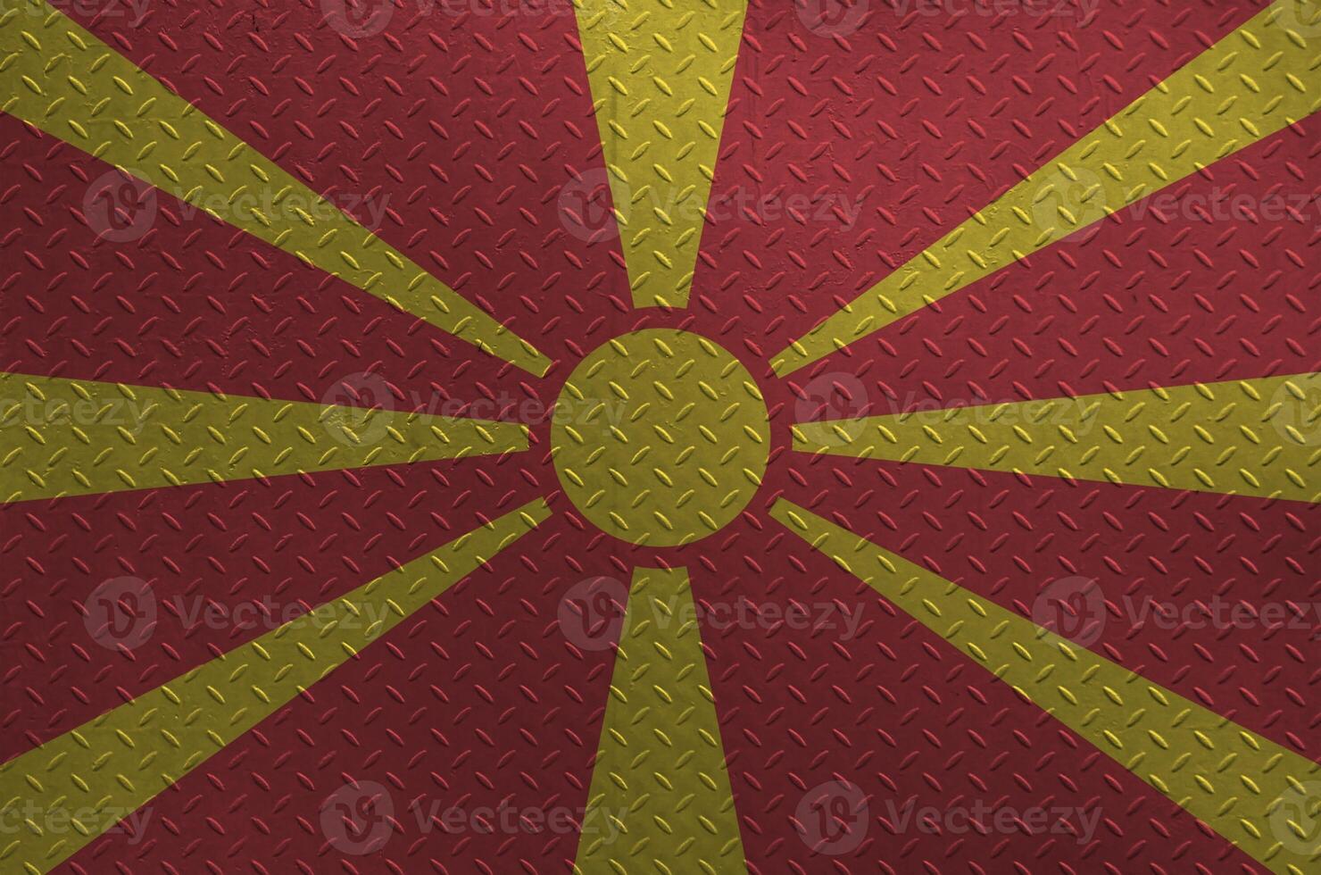 Macedonia flag depicted in paint colors on old brushed metal plate or wall closeup. Textured banner on rough background photo