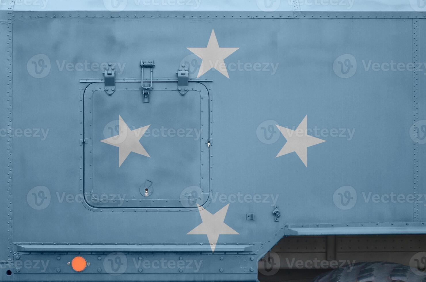 Micronesia flag depicted on side part of military armored truck closeup. Army forces conceptual background photo