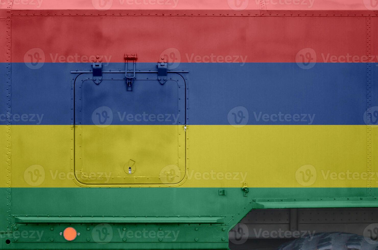 Mauritius flag depicted on side part of military armored truck closeup. Army forces conceptual background photo