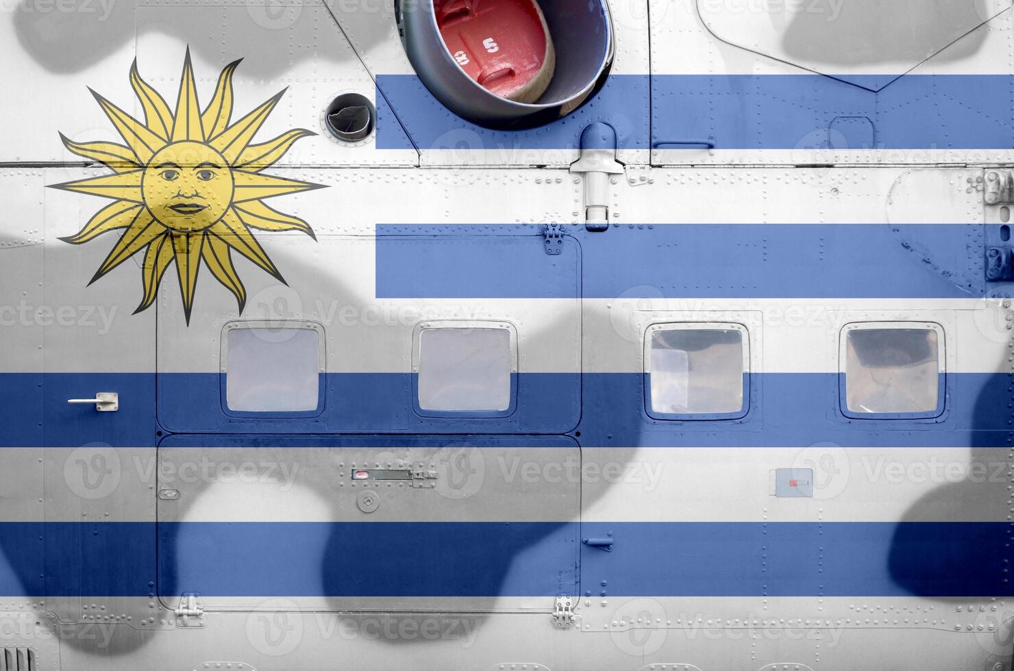 Uruguay flag depicted on side part of military armored helicopter closeup. Army forces aircraft conceptual background photo